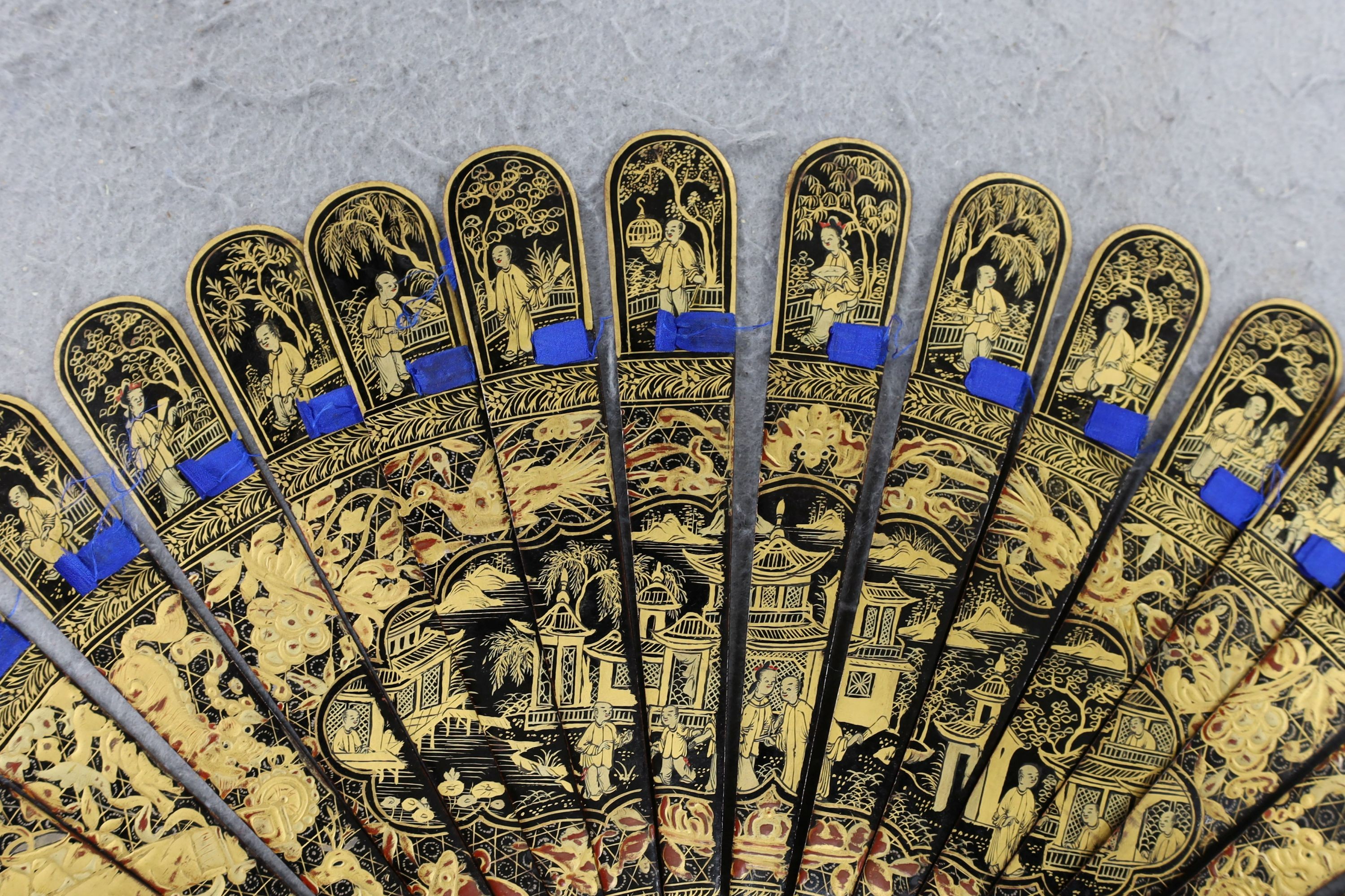 A Chinese gilt-decorated lacquer fan in a brocade covered case, 19th century